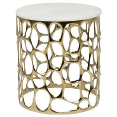 a white and gold side table with circles on it