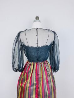 "This Miss Elliette dress is just so unique! The top is black with an under bodice with floral embroidered detail. It has a sheer overlay with balloon sleeves with elastic in the cuffs. Back zipper an button closures. So elegant! Flared skirt with maroon and olive green stripes. Condition: Great! No Flaws To Note! Measurements: Bust: 36\" Waist: 26\" Hips: Full Length: 48.5\" ---------- I do not accept returns currently. Please read the description in detail and ask any and all questions before Black Vintage Dress For Spring Costume Party, Black Vintage Dress For Costume Party In Spring, Vintage Summer Dresses With Sheer Sleeves, Summer Vintage Dresses With Sheer Sleeves, Retro Long Sleeve Vintage Dress For Party, Retro Vintage Long Sleeve Dress For Party, Lined Vintage Dress For Spring Party, Retro Fitted Sheer Dresses, Black Vintage Dress For Summer Evenings