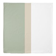 the side of a blanket with two different colors on it and one is white, beige, and green