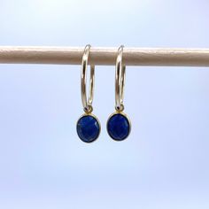 Lapis lazuli (blue) mini oval (7x9mm) crystal gemstone drop earrings on 22 Carat gold vermeil small hoop (16mm wide) sleeper  ear wires. Sold separately on 925 Sterling Silver hoops. Sleeper ear wires are tubular in design with one end slotting a little into the other to form an endless ring. They are lightweight and uncomplicated. Vermeil is a high quality form of gold plating in which a thick layer of gold (this must be more than 2.5 microns and between 14 Carat and 22 Carat) is coated over 92 Blue Hypoallergenic Hoop Jewelry, Blue Hypoallergenic Small Hoop Jewelry, Hypoallergenic Blue Small Hoop Jewelry, Hypoallergenic Blue Hoop Jewelry, Faceted Teardrop Sapphire Jewelry, Teardrop Sapphire Faceted Jewelry, Blue Hoop Huggie Earrings Gift, Blue Huggie Hoop Earrings For Gift, Blue Huggie Hoop Earrings As Gift