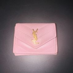 This Is An Authentic Saint Laurent Grain De Poudre Matelasse Chevron Monogram Tiny Wallet In Tender Pink. This Elegant Wallet Is Crafted Of Chevron-Quilted Textured Calfskin Leather In Light Pink. The Wallet Features A Prominent Polished Gold Ysl Logo On The Crossover Flap. The Wallet Snaps Open To A Pink Leather Interior With A Billfold And Patch Pockets. Shows Mild Wear. Yves Saint Laurent Wallet, Elegant Wallet, Ysl Logo, Chevron Quilt, Luxury Wallet, Saint Laurent Wallet, Lv Wallet, Pink Leather, Leather Interior