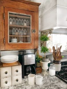 the kitchen counter is covered with dishes and utensils