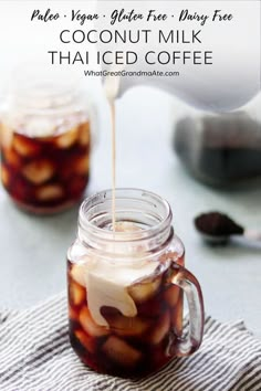 a mason jar filled with homemade coconut milk that is being poured into the glass for iced coffee