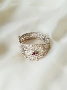 This 925 Sterling Silver Filigree bracelet is purely handmade and natural Ruby is used as gemstone. Circumference: 7,9 in Width: Front 1,6 in - Back 0,6 in Filigree (Telkari) was a traditional handcraft in Anatolia and Mesopotamia, and still being one of the most important artisan styles in some regions of Turkey, especially in Ankara. Filigree is a kind of jewelry metalwork of silver and gold. Tiny beads and twisted threads are soldered together and arranged in different artistic motifs by silv Exquisite Silver Bangle With Intricate Design, Traditional Flower-shaped Jewelry For Formal Occasions, Traditional Gemstone Cuff Bracelet, Wedding Sterling Silver Filigree Bangle Bracelet, Wedding Sterling Silver Filigree Bangle, Handmade Luxury Flower Shaped Jewelry, Bohemian Gemstone Wedding Bangle, Handmade Sterling Silver Elegant Cuff Bracelet, Handmade Elegant Sterling Silver Cuff Bracelet