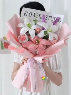 a woman holding a bouquet of flowers in front of her face with the words flower studio on it