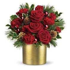 a golden vase filled with red roses and pine cones on top of a white background