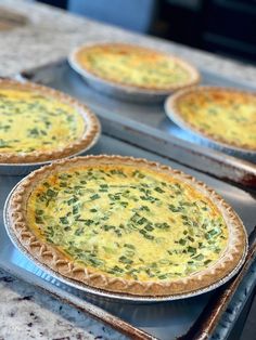 four pies sitting on top of metal pans