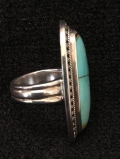 "Ring ~ Artist: Teresa Bradford-Cole Natural Stone Oval Turquoise Heavy Gauge Sterling Silver Be bold in style with this stunning long turquoise stone It features a long oval natural stone Many tribes considered turquoise to be a stone of the sky and wearing items of turquoise jewelry provided protection, good health, and long life. Size: 8 Length: 1 3/4\" Width:3/4 You deserve to know about my fabulous Treasure chest Modern Tribal Jewelry, Statement Piece Jewelry, Art to Wear Jewelry, Fantastic Elegant Green Turquoise Ring, Artisan Oval Multi-stone Turquoise Ring, Oval Multi-stone Turquoise Ring, Oval Turquoise Multi-stone Ring, Turquoise Multi-stone Round Gemstones, Turquoise Multi-stone Gemstones, Handmade Turquoise Ring For Formal Occasions, Handmade Oval Turquoise Ring For Formal Events, Handmade Oval Turquoise Ring For Formal Occasions