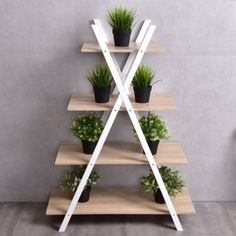 three tiered wooden shelf with plants on it