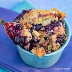 blueberry cobbler in a bowl with a spoon on the side, ready to be eaten