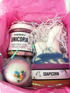 unicorn soap, soap scrubs and other items in a pink gift box