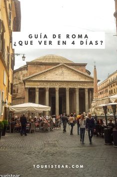 people are walking around in front of an old building with pillars and columns on it