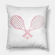 two tennis racquets on a white pillow with pink outline in the middle