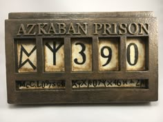 a metal plaque with numbers and symbols on it that reads azkaban prison y3890