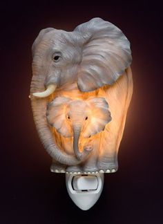 an elephant night light is shown on a black background