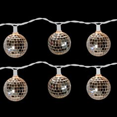 several disco ball lights hanging from a wire