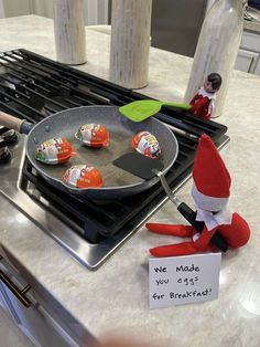 an elf frying marshmallows in a pan on top of the stove