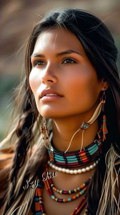 a woman with long hair wearing native jewelry