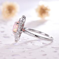 This is an pink opal engagement ring white gold. The stones are Opal and VVS man made cz diamond. The center opal is about 6x8mm oval Cut. The stones can be replace with other gemstones.For example,if you don't like the CZ accent,you can ask me replace it with tourmaline,aquamarine,diamond,emerald,sapphire... For custom making jewelry,it can be made in 2 different metal. 1,Solid gold,including 14/18k white/rose/yellow gold. 2,925 sterling silver with white/yellow/rose gold plated. High quality w Pink Opal Ring With Accent Stones As Gift, Pink Opal Gemstone Ring For Anniversary, Pink Opal Ring In Sterling Silver For Anniversary, Pink Sterling Silver Opal Ring For Anniversary, Elegant Pink Opal Ring For Anniversary, Pink Opal Ring For Anniversary, Fine Jewelry, Pink Opal Ring For Anniversary, Elegant Pink Opal Ring, Silver Opal Ring With Halo For Wedding