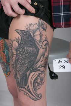 a person with a bird tattoo on their thigh