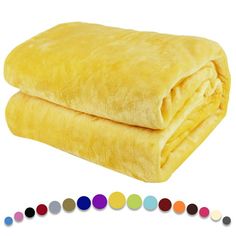 a yellow blanket with multicolored circles on the bottom and side, next to it