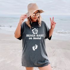 Introducing our "Beach Baby on Board" Comfort Colors shirt, perfect for your summer pregnancy announcement by the sea. Whether it's a cruise or beach vacation, share your joy in style. Ideal for baby showers or gender reveals, its soft fabric ensures comfort while flaunting your bump. Family Matching Cotton Tops For Beach, Family Matching Soft-washed Summer T-shirt, Summer Maternity Short Sleeve Tops, Summer T-shirt For Family Vacation At The Beach, Summer Beach T-shirt For Family Vacation, Family Matching Short Sleeve Beach T-shirt, Family Matching Cotton Beach T-shirt, Family Matching Tops For Vacation In Summer, Summer Tops For Family Beach Vacation