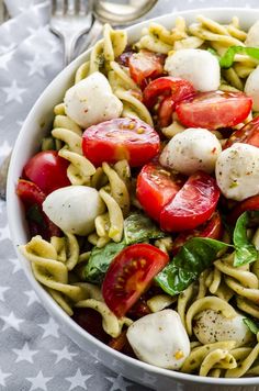 a pasta salad with mozzarella and cherry tomatoes