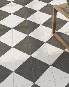 a coffee table sitting on top of a white and black checkerboard tile floor