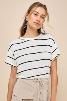 Create an OOTD that's casually compliment-worthy with the Lulus Laid-Back Perfection White Striped Knit Short Sleeve Top! Soft, lightweight sweater knit, with a black striped design throughout, shapes this effortless top with a classic crew neckline framed by short sleeves. The relaxed, boxy bodice creates the ideal, breezy day 'fit! Fit: This garment fits true to size. Length: Size medium measures 21.5" from shoulder to hem. Bust: Great for any cup size. Waist: Not Fitted - comfortable room thr Casual Pointelle Knit Top For Layering, Chic Crew Neck Sweater For Day Out, Chic Black Relaxed Fit Knit Top, Black Casual Knit Top For Layering, Casual Black Knit Top For Layering, Striped Textured Knit Top For Layering, Chic Striped Crew Neck Knit Top, Casual Striped Sweater For Day Out, Trendy Striped Crew Neck Knit Top