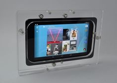 an image of a tablet in a clear plastic case on a white surface with screws