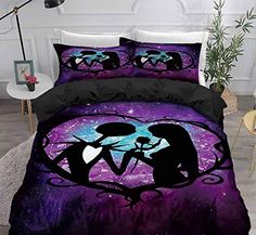 a bed covered in purple and black comforter with two cats on the night sky