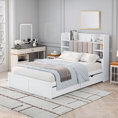 a white bed sitting on top of a wooden floor next to a desk and chair