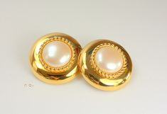 Beautiful vintage signed Monet gold round faux pearl clip-on earrings. It measures approximately 1 3/8" in diameter, 0.5" thick and one earring weighs 0.7 oz.  It is Estate item in excellent condition, there is no wear to the gold and the clasp works very well. We combine shipping.  Thank You for visiting our Etsy https://www.etsy.com/shop/VictoryIssweet store! Monet Earrings, Monet Jewelry, Vintage Signs, Earrings Gold, Faux Pearl, Clip On Earrings, Gold Earrings, Gold Tones, Jewelry Design