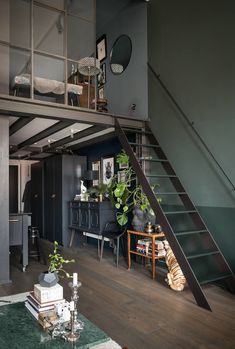 a living room filled with furniture and a metal stair case