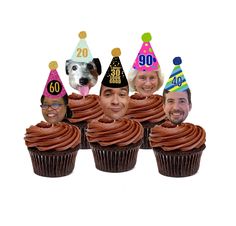 a group of cupcakes with faces of people and dogs on top of them