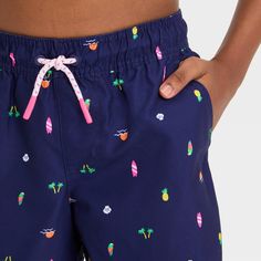 Update your child's swim apparel for swimming, surfing or having fun at the beach with these Shapes Printed Swim Shorts from Cat & Jack™. These lightweight swim trunks are designed with a built-in brief for comfort and extra coverage both in and out of the water. Featuring a colorful print of different tropical-themed shapes on a deep blue backdrop, these mid-rise swim trunks pair with a variety of rash guards, tees or tanks for versatile swimwear options. The full elastic waistband with an adju 4-way Stretch Swim Trunks With Built-in Shorts, Blue Swim Trunks With Built-in Shorts, Solid Color 4-way Stretch Swim Trunks With Built-in Shorts, Blue 4-way Stretch Swim Trunks With Built-in Shorts, Blue 4-way Stretch Swim Trunks, Swimming Outfit, Blue Backdrops, Printed Swim, Cat & Jack