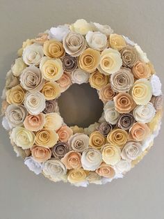 a paper flower wreath hanging on the wall