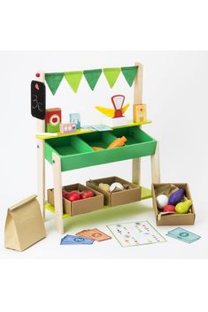 a wooden toy desk with lots of toys in it