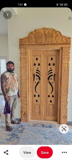 a man standing in front of a carved wooden door