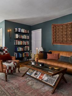 a living room filled with furniture and bookshelves