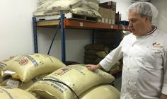 a man standing in front of stacks of sand bags