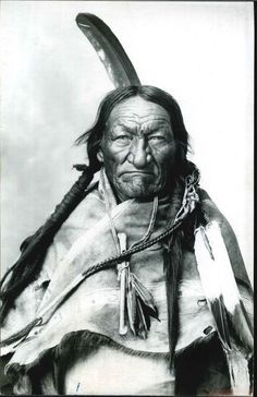 an old black and white photo of a native american man