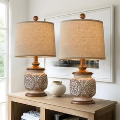 two lamps sitting on top of a wooden table