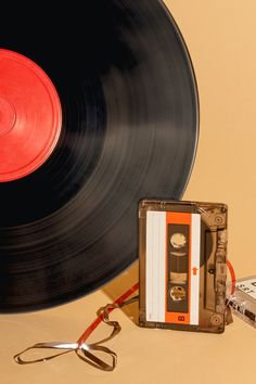 an old fashioned record player next to a pair of scissors