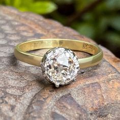 a diamond ring sitting on top of a rock