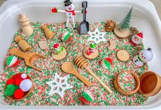 an assortment of wooden spoons and other kitchen utensils in a play tray