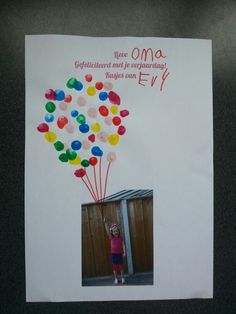 a child holding balloons in front of a birthday card with the words oma on it