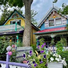 the colorful houses are all painted in different colors and styles, along with many flowers