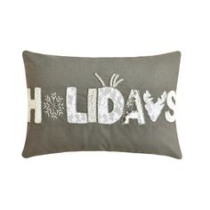 a pillow with the word holidays written on it and snowflakes in white letters