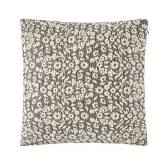 a black and white pillow with an ornate pattern